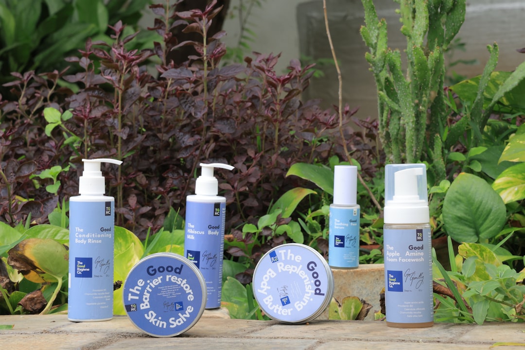 Skincare products displayed outdoors with lush greenery