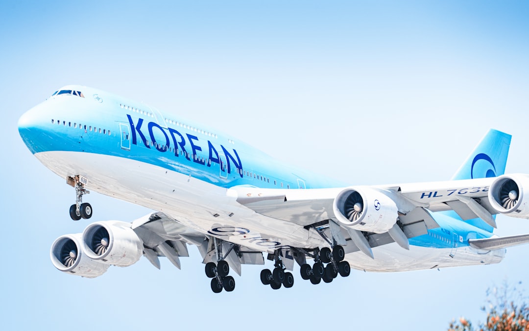 A korean air plane takes flight from the sky.