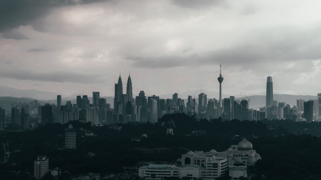 city skyline under white clouds during daytime