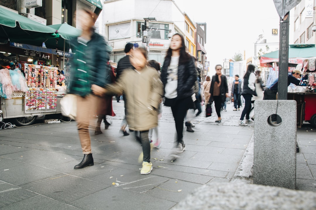 a group of people walking down a street