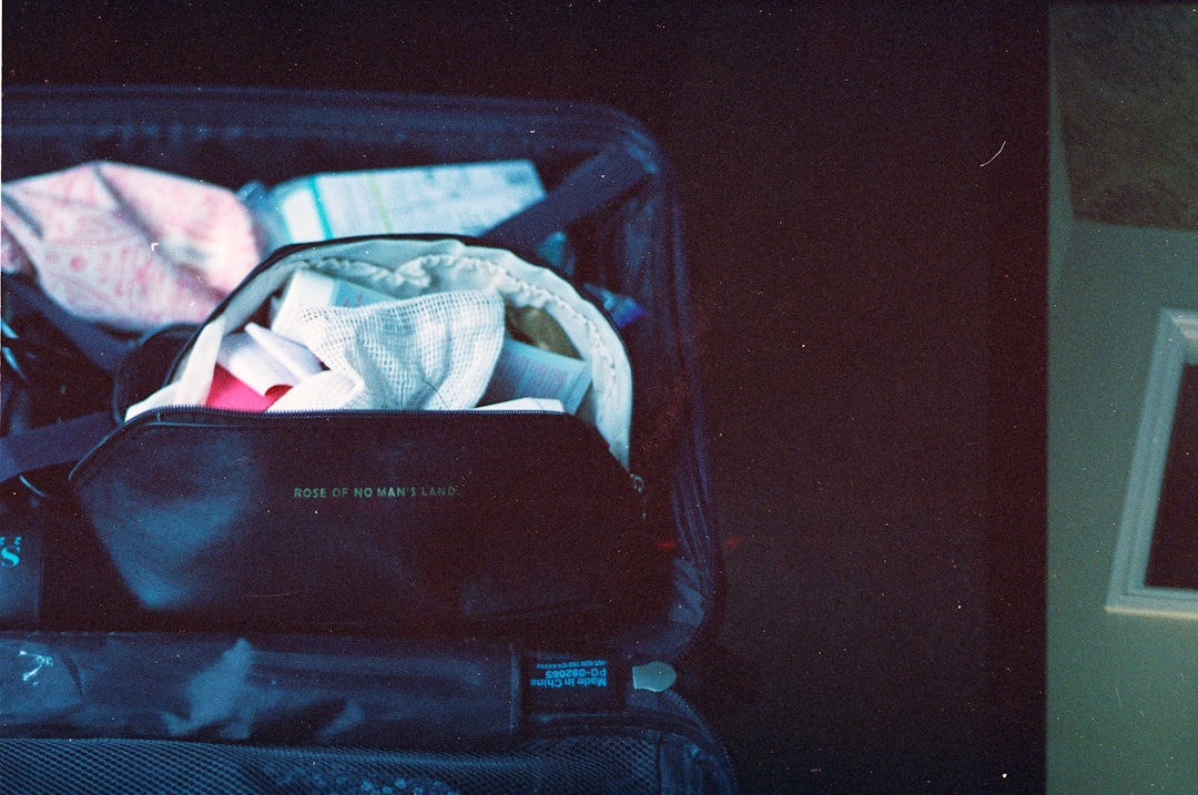 Packed suitcase with clothes and toiletries inside.