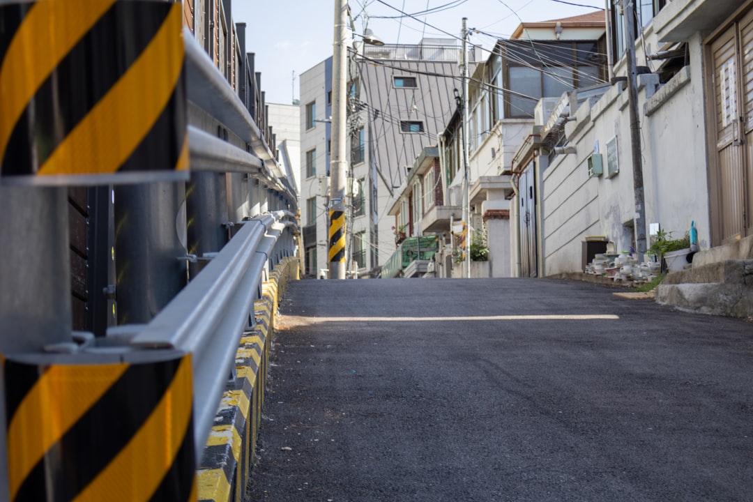 A yellow and black barricade on a city street