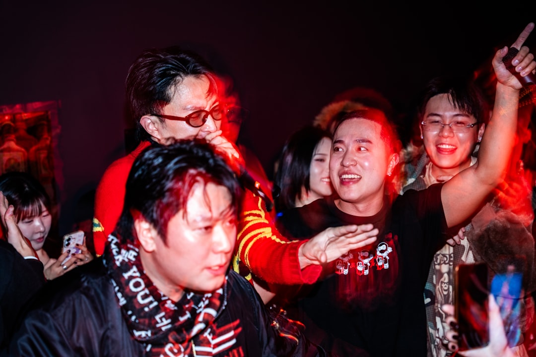 People enjoying a lively party with red lighting