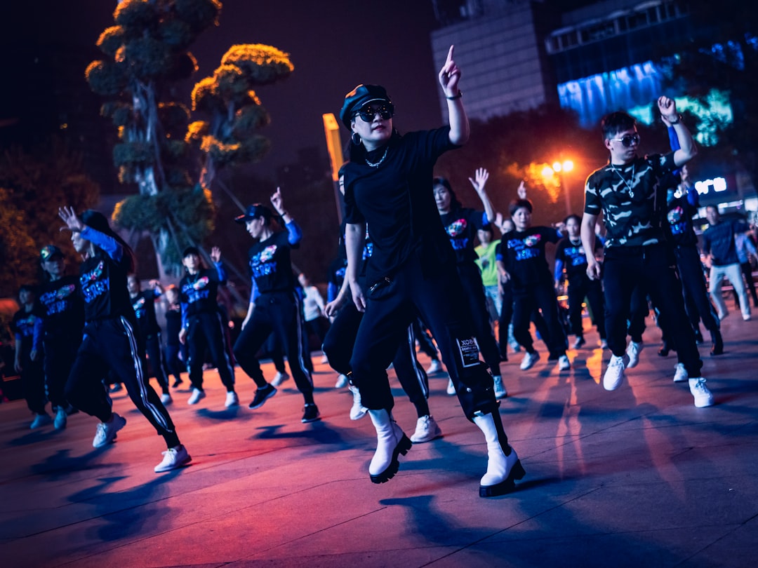man in black and white costume standing on red floor