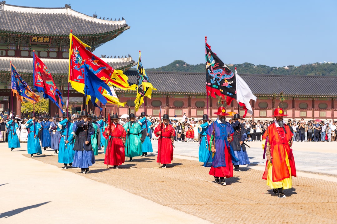 A group of people walking down a street holding flags