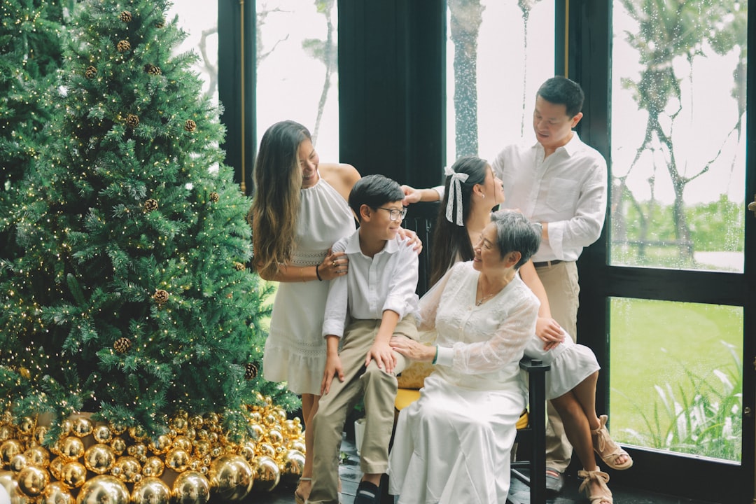 Family posing near a decorated christmas tree