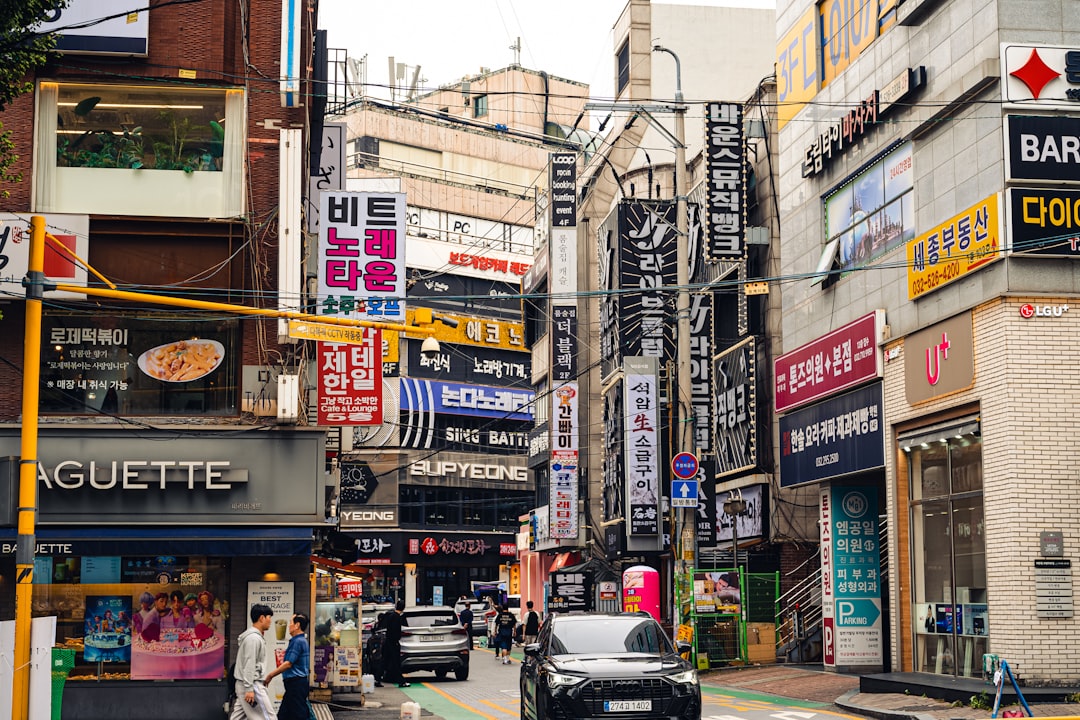 Busy street with many signs and cars in city.