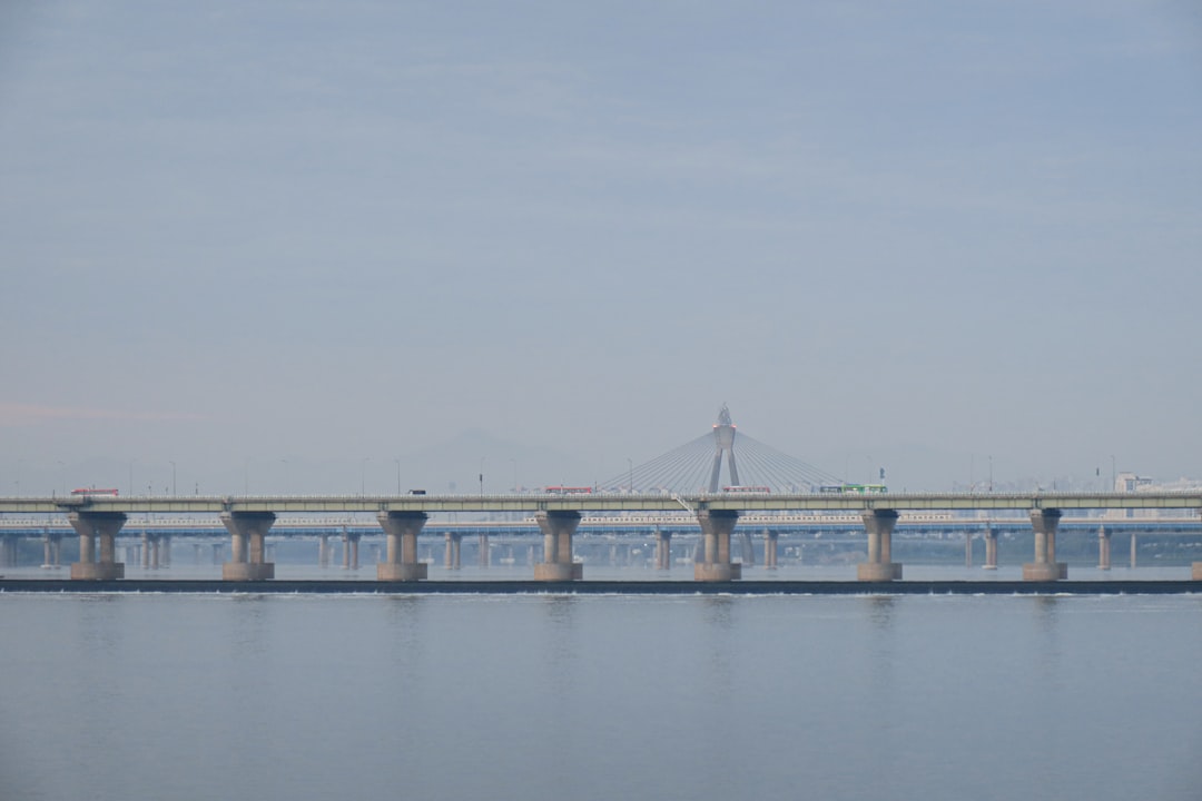 bridge over water under white sky during daytime