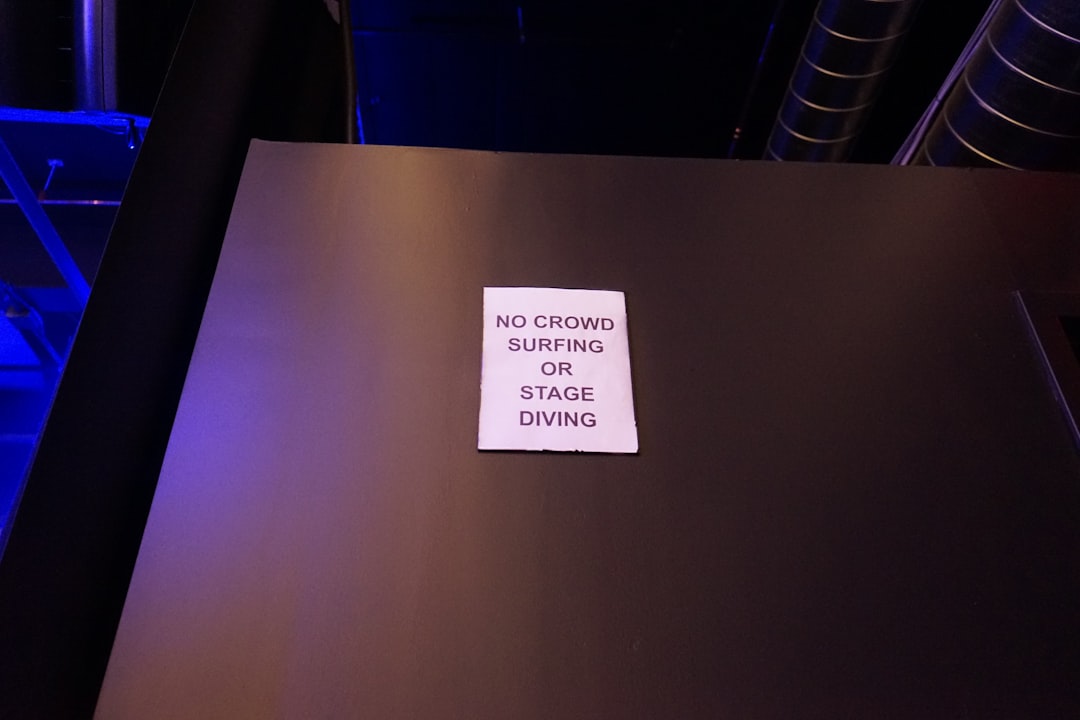 Sign says no crowd surfing or stage diving.