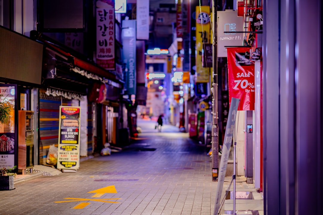 Empty street with glowing signs at night