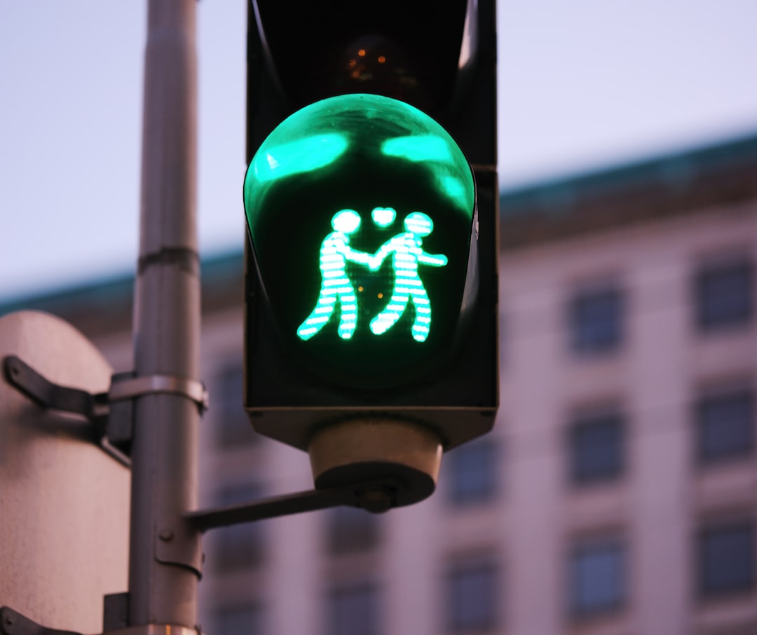 A traffic light with a green pedestrian crossing signal