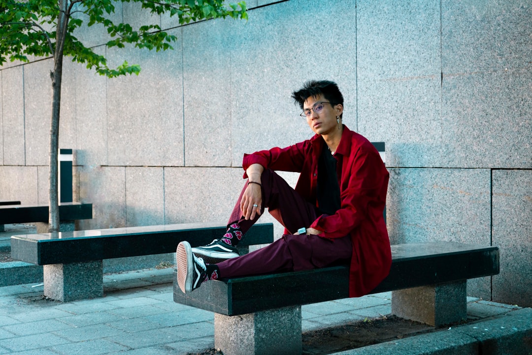 a man sitting on a bench in front of a building
