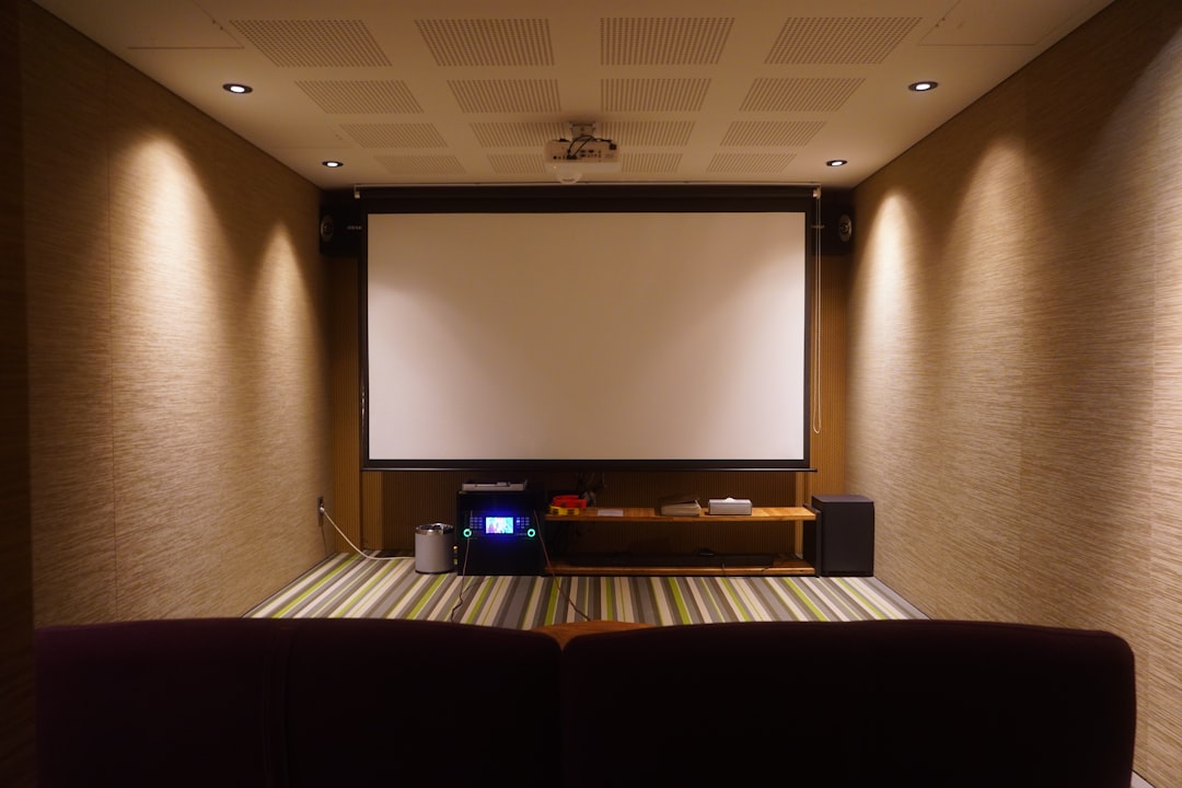 Home theater with a screen and comfortable seating.