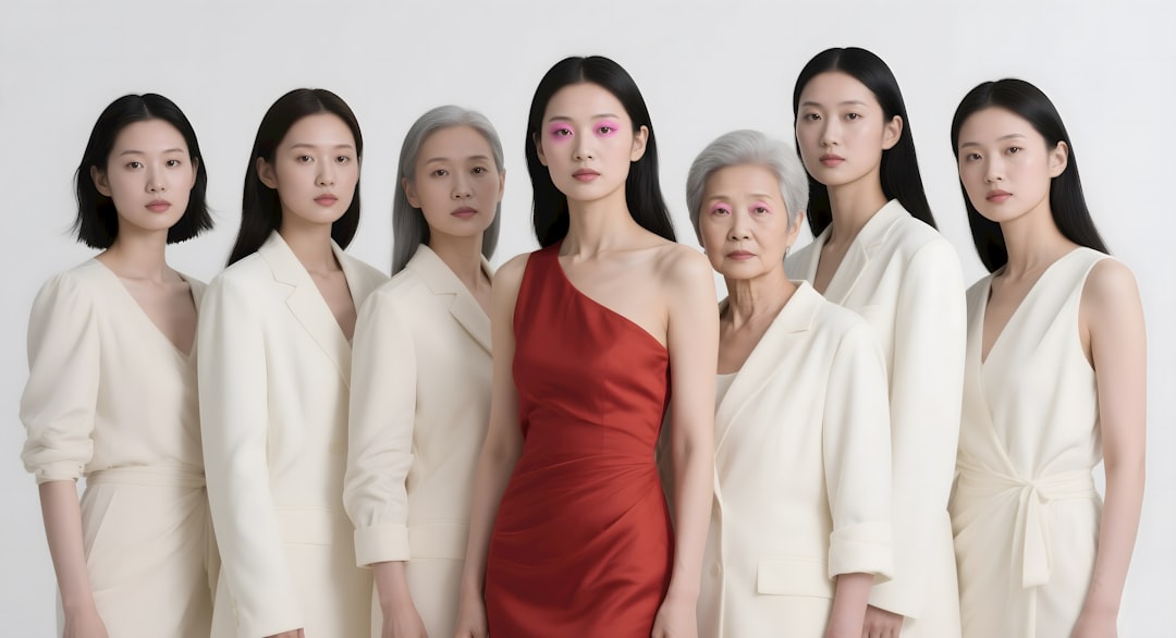 Seven asian women stand together in a portrait.