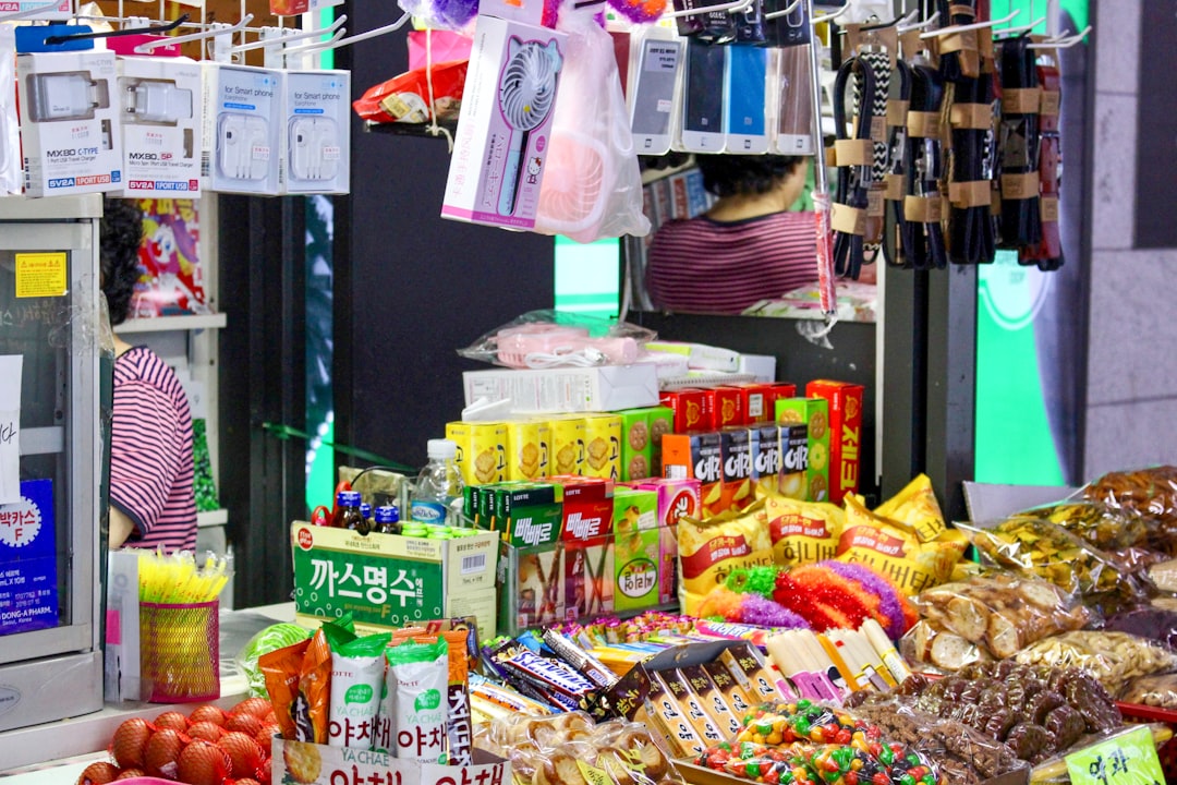 A market stall displays a variety of snacks and goods.