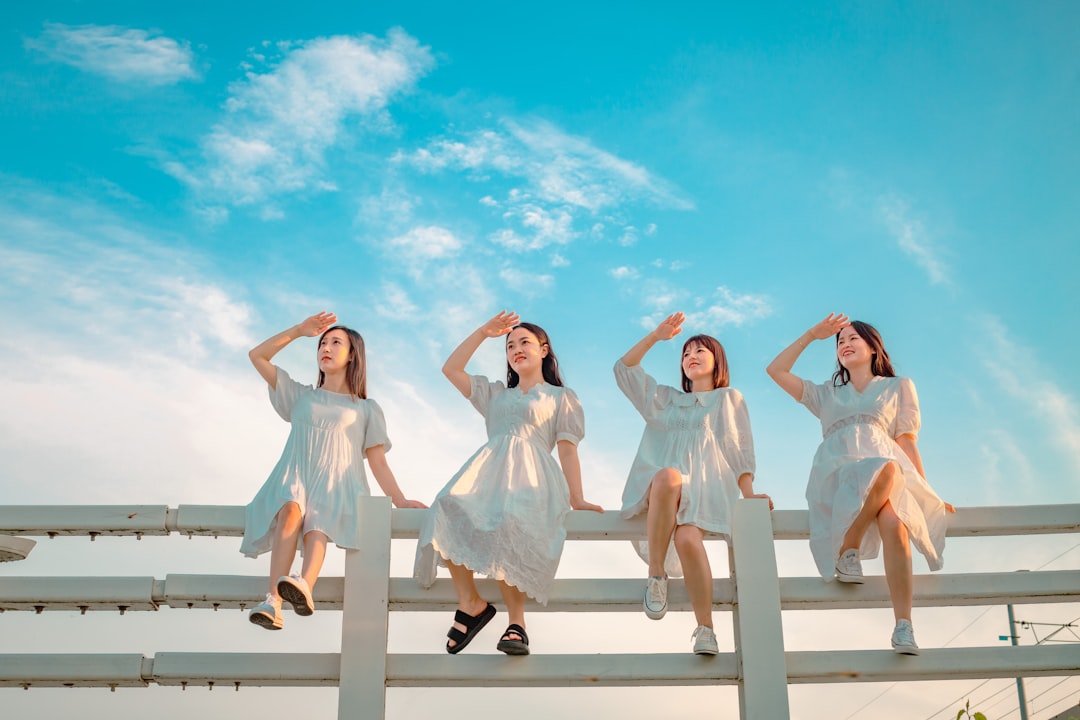 a group of women in white dresses