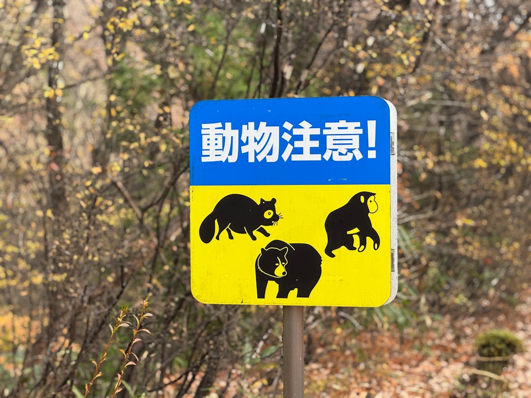 A blue and yellow sign with black bears on it