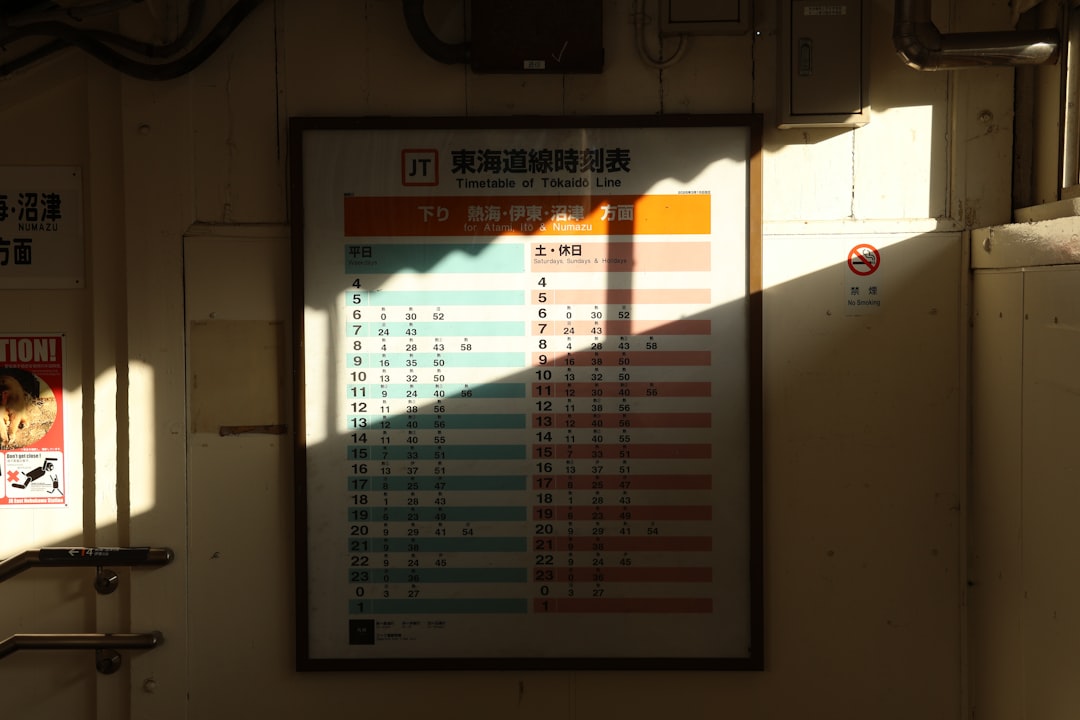 A timetable with sunlight casting a shadow.