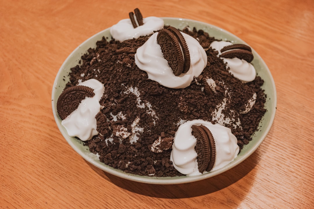 A bowl of cookies and cream dessert with whipped cream