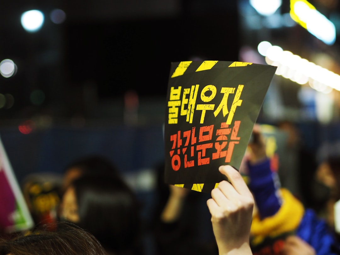 person holding Korean signage