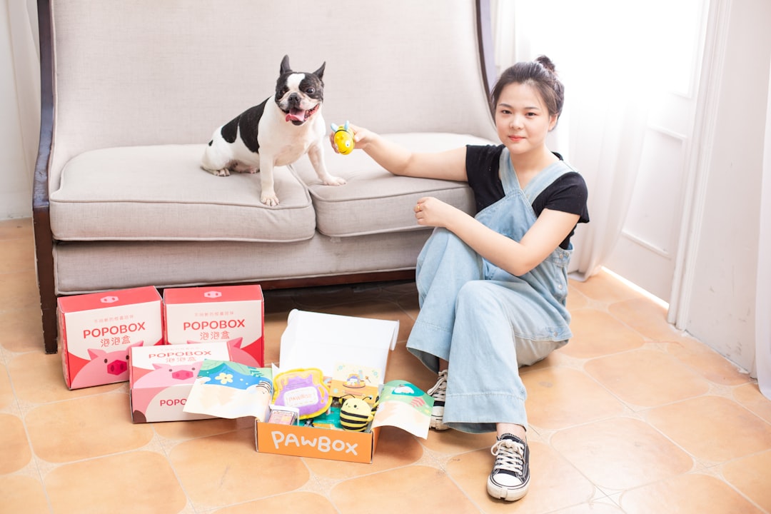 Woman and dog with pet toys and subscription box.