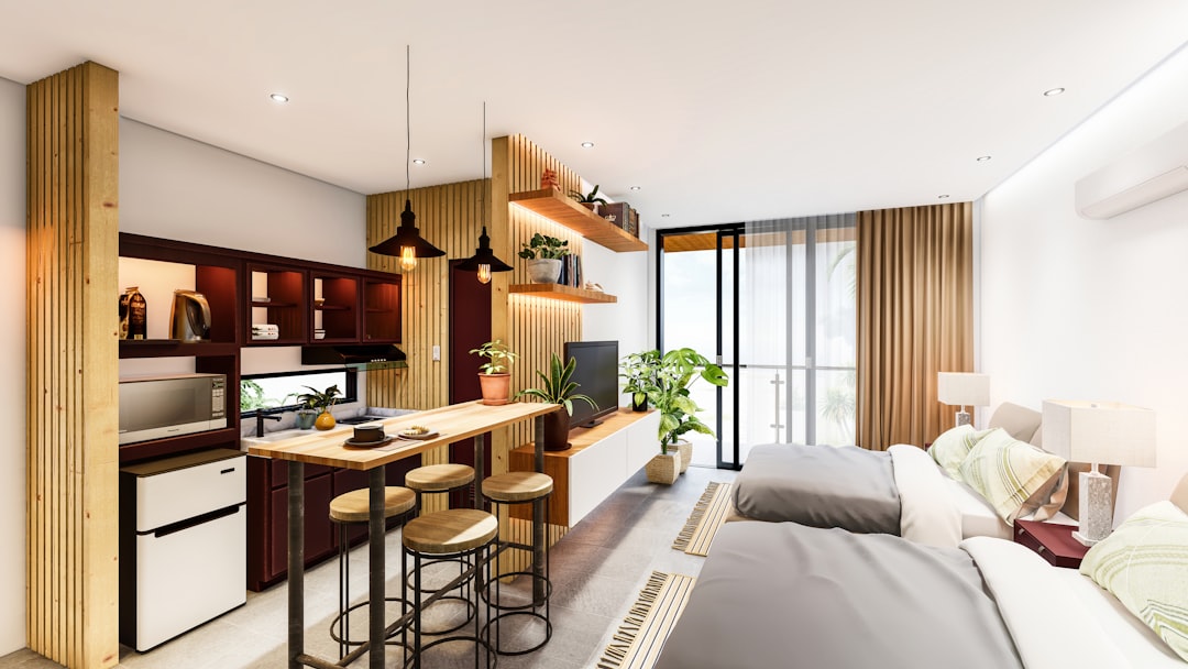 A living room with a bed a bar and some chairs