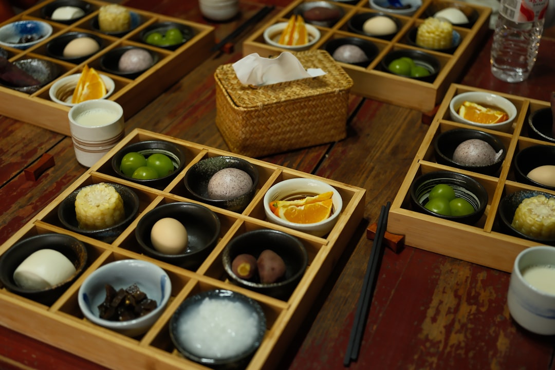 Assortment of small dishes in wooden trays on table