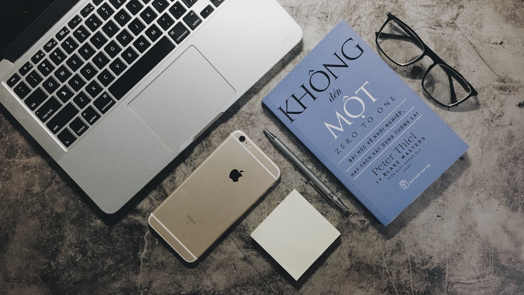 silver ipad beside silver macbook