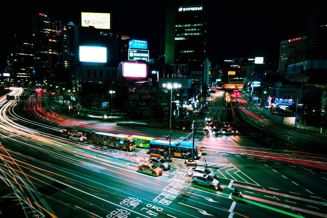 a city street filled with lots of traffic at night