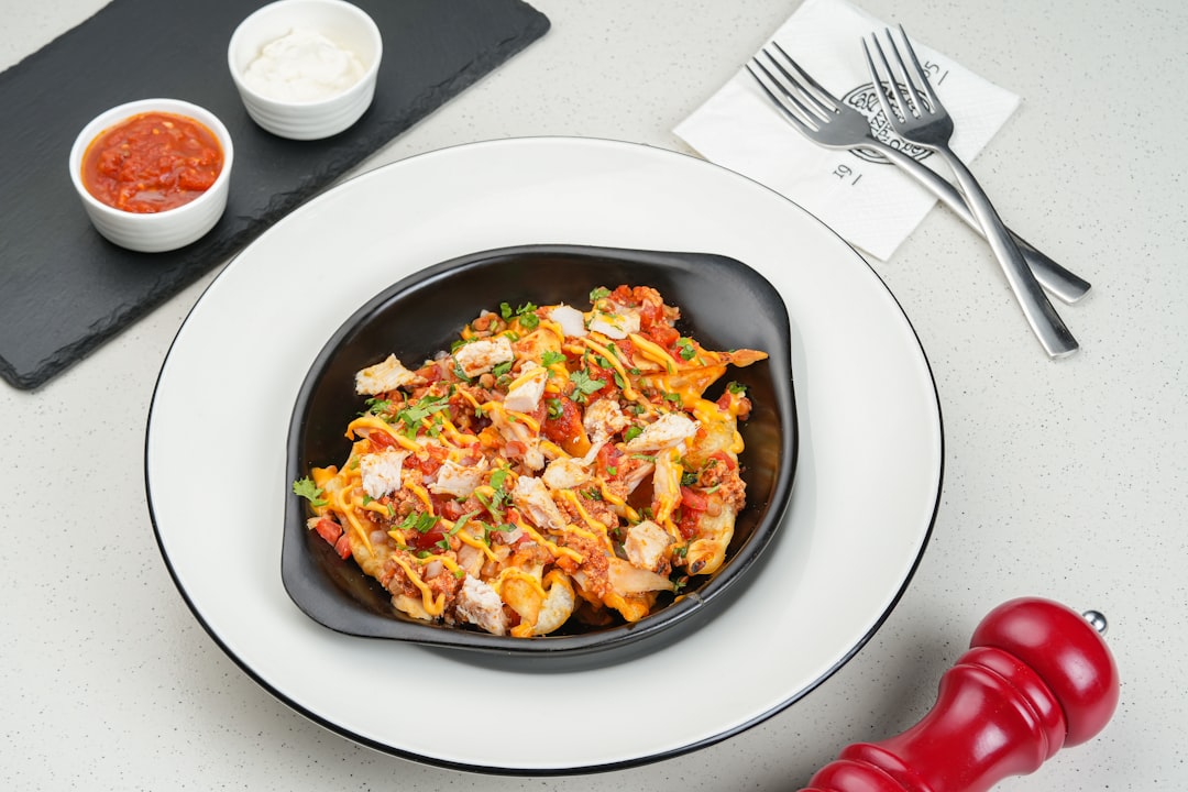 A plate of food on a table with a knife and fork