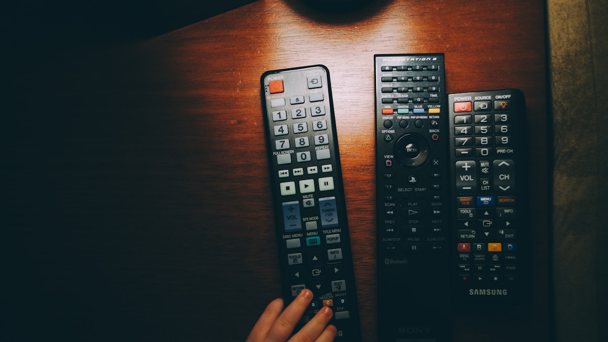 person confused choosing remote control