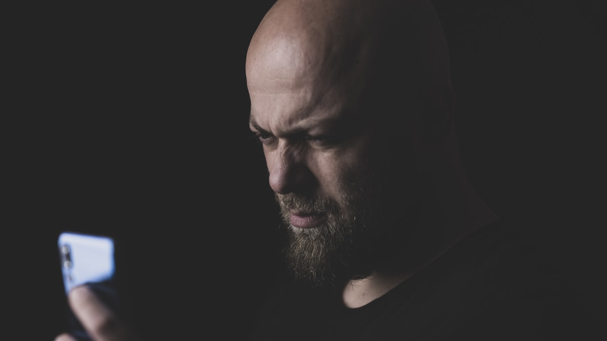 frustrated person looking at phone screen